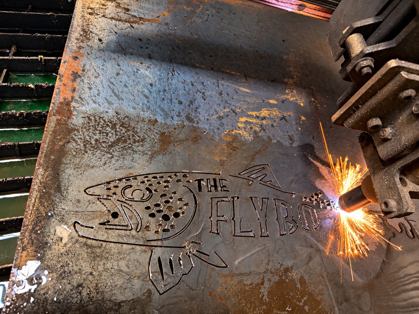 Overhead view of a laser cutting a custom profile from steel plate